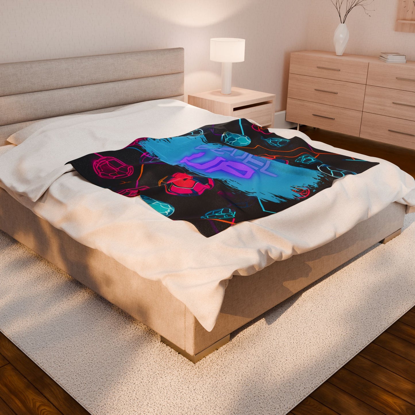 Colorful blanket with abstract design on a bed in a bedroom setting with sunlight coming in through a window