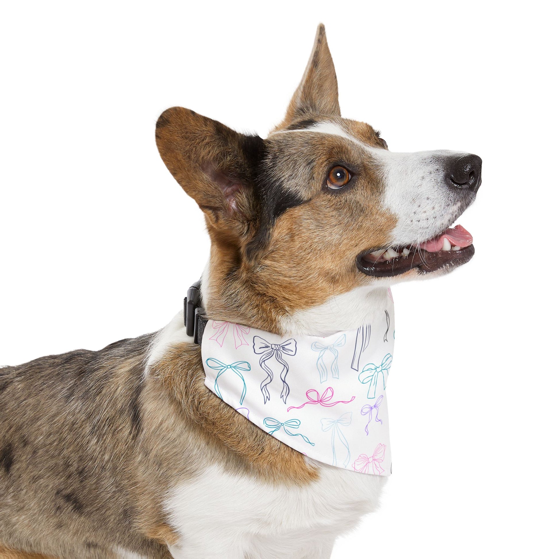 side view of a dog wearing a bandana with colorful bow pattern on a white background