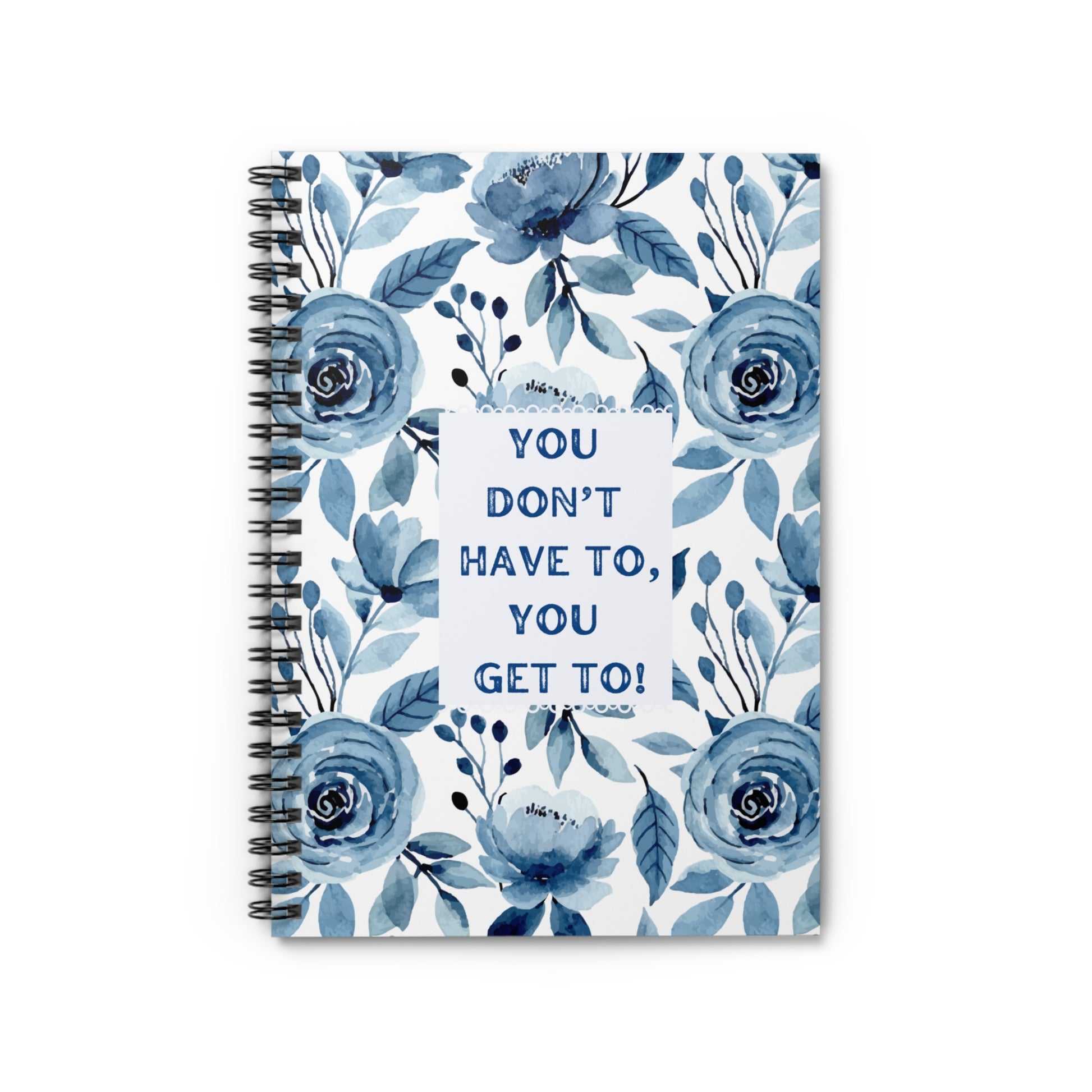 Front over view of notebook with blue floral design and motivational quote on a white background