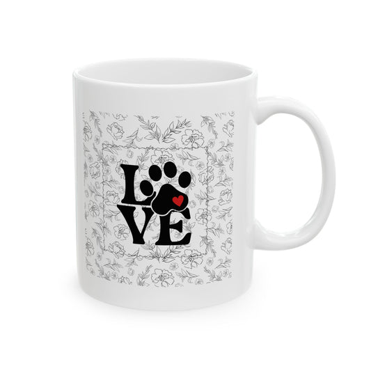 White mug with paw print design and floral patterns on a white background