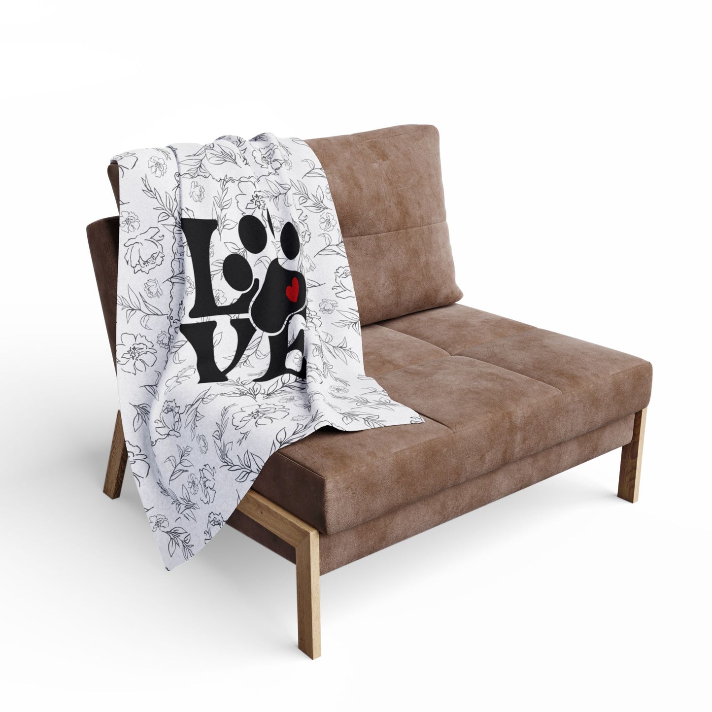 Brown sofa with a small blanket featuring paw prints and the word 'LOVE' on a white background
