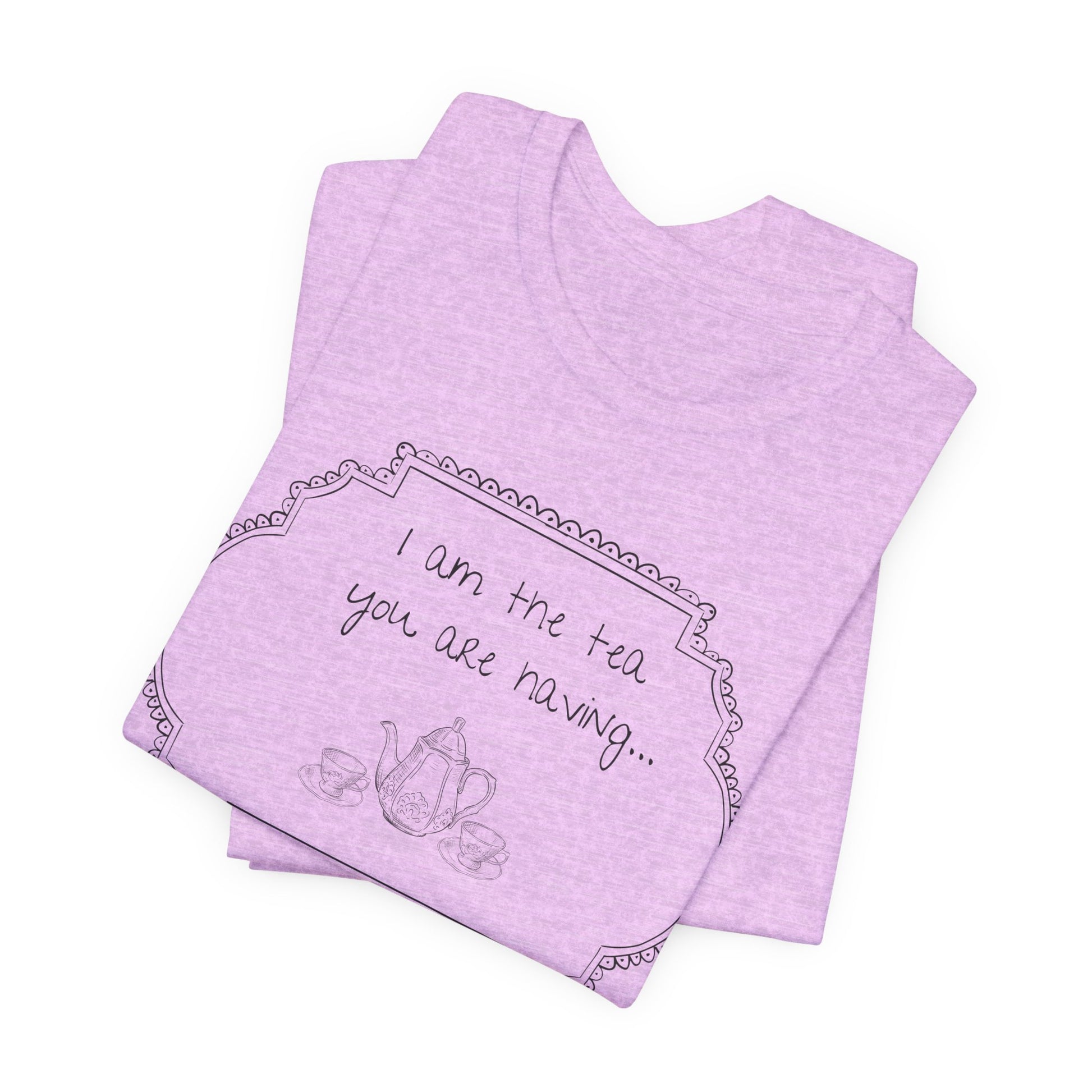 Folded light purple t-shirt with tea-themed design and text on a white background