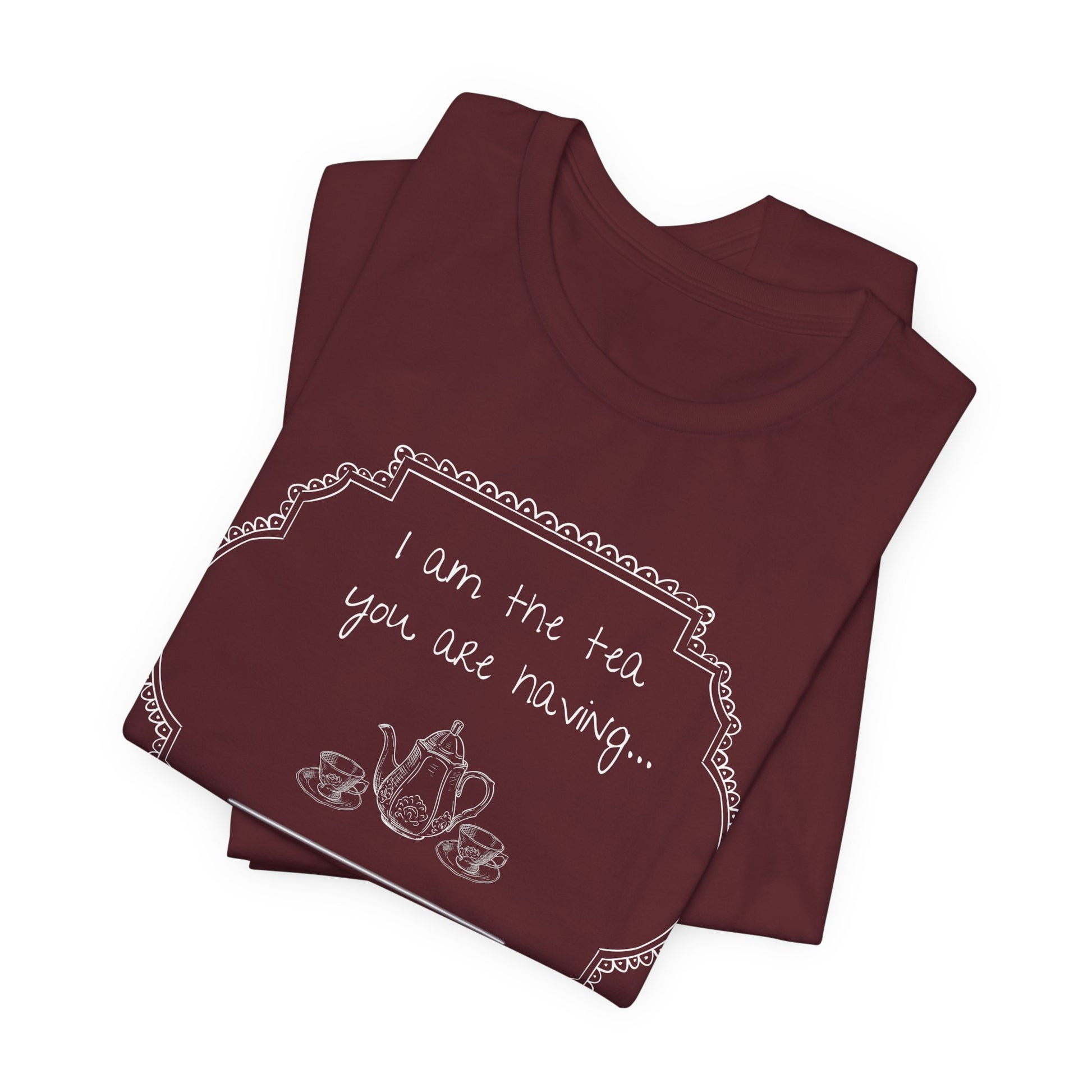 Two maroon t-shirts stacked on a white background