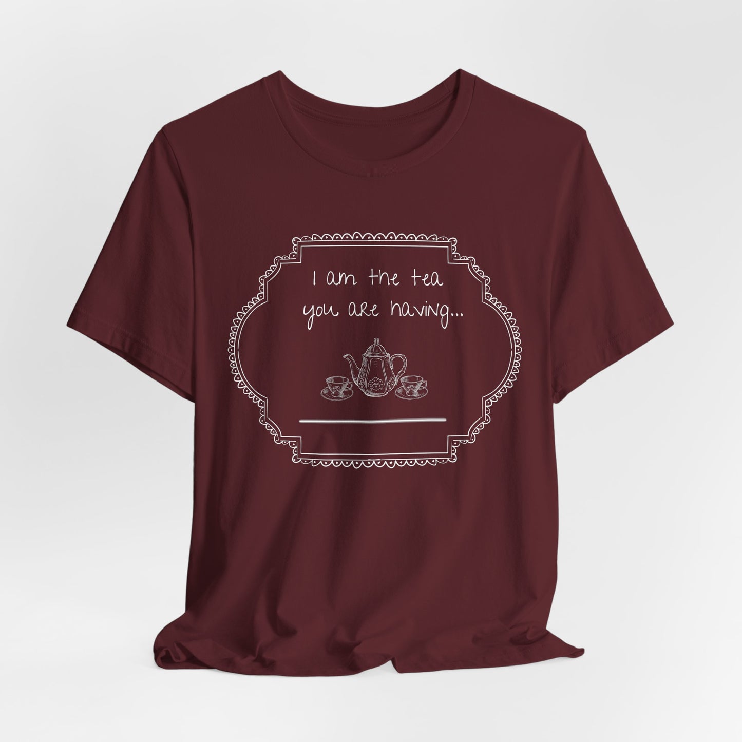 Maroon t-shirt with white graphic and text on a light gray studio background