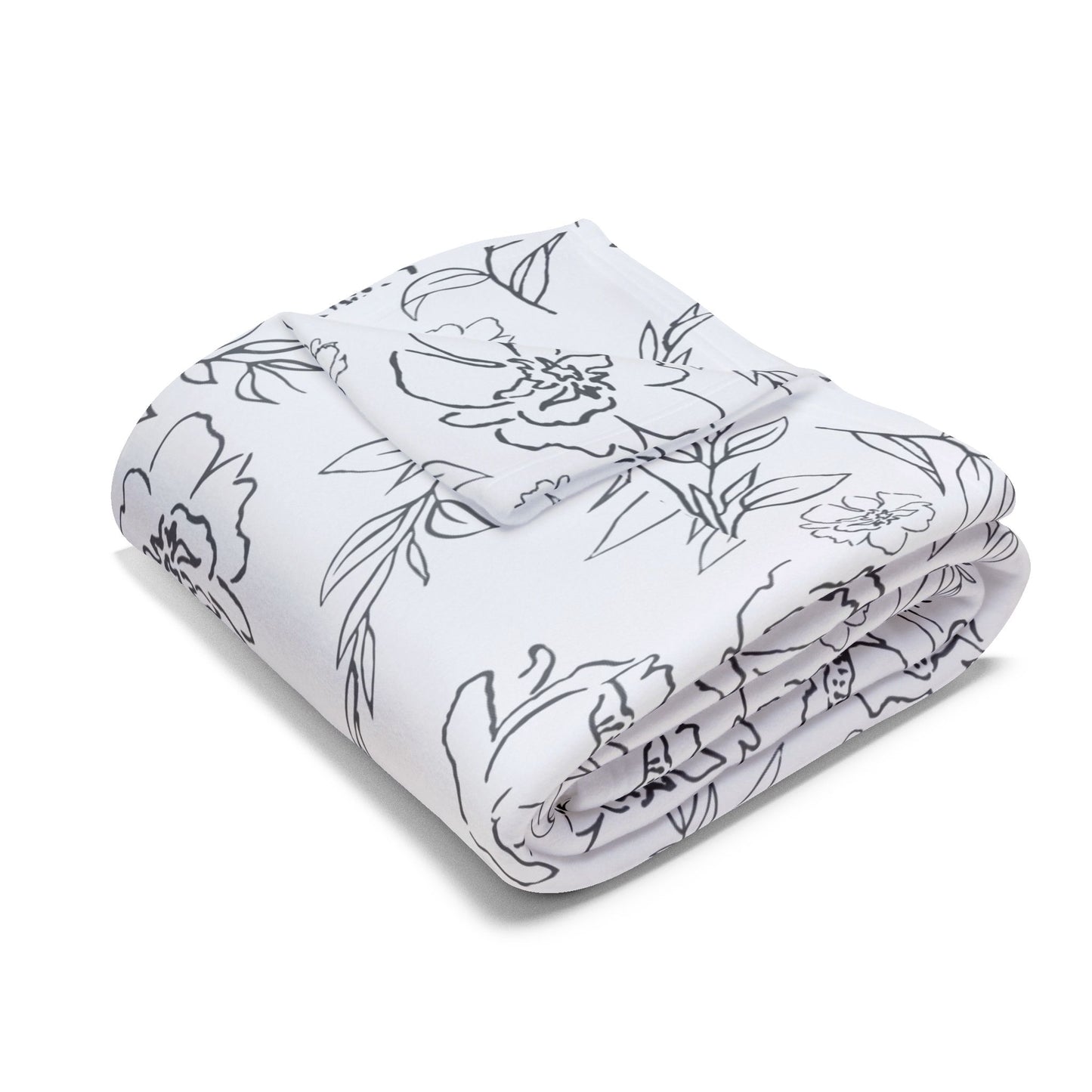 Larger size blanket with folded corner and with black floral pattern on white background
