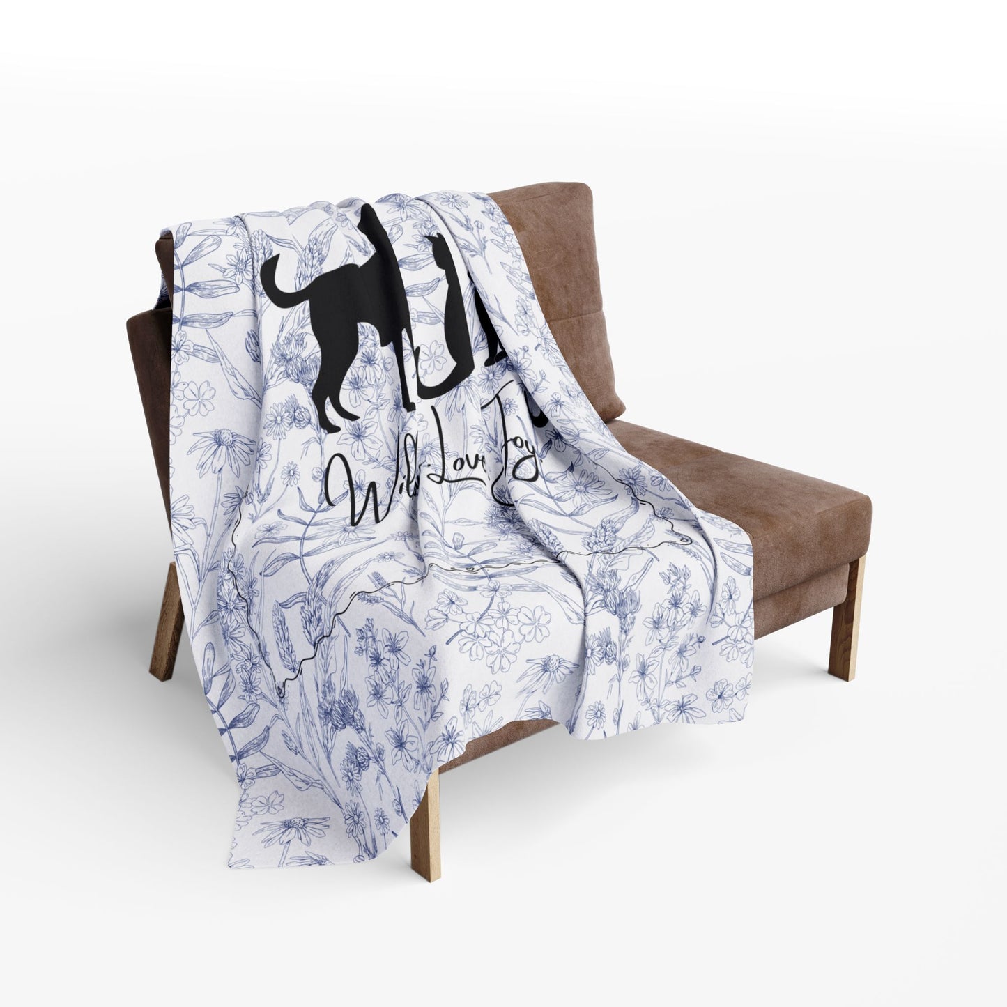 Larger size Floral patterned blanket with dog illustrations draped over a brown chair.