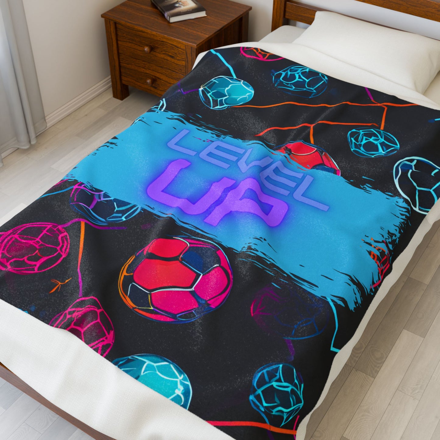 Larger size colorful blanket with 'Level Up' text on a bed in a bedroom setting