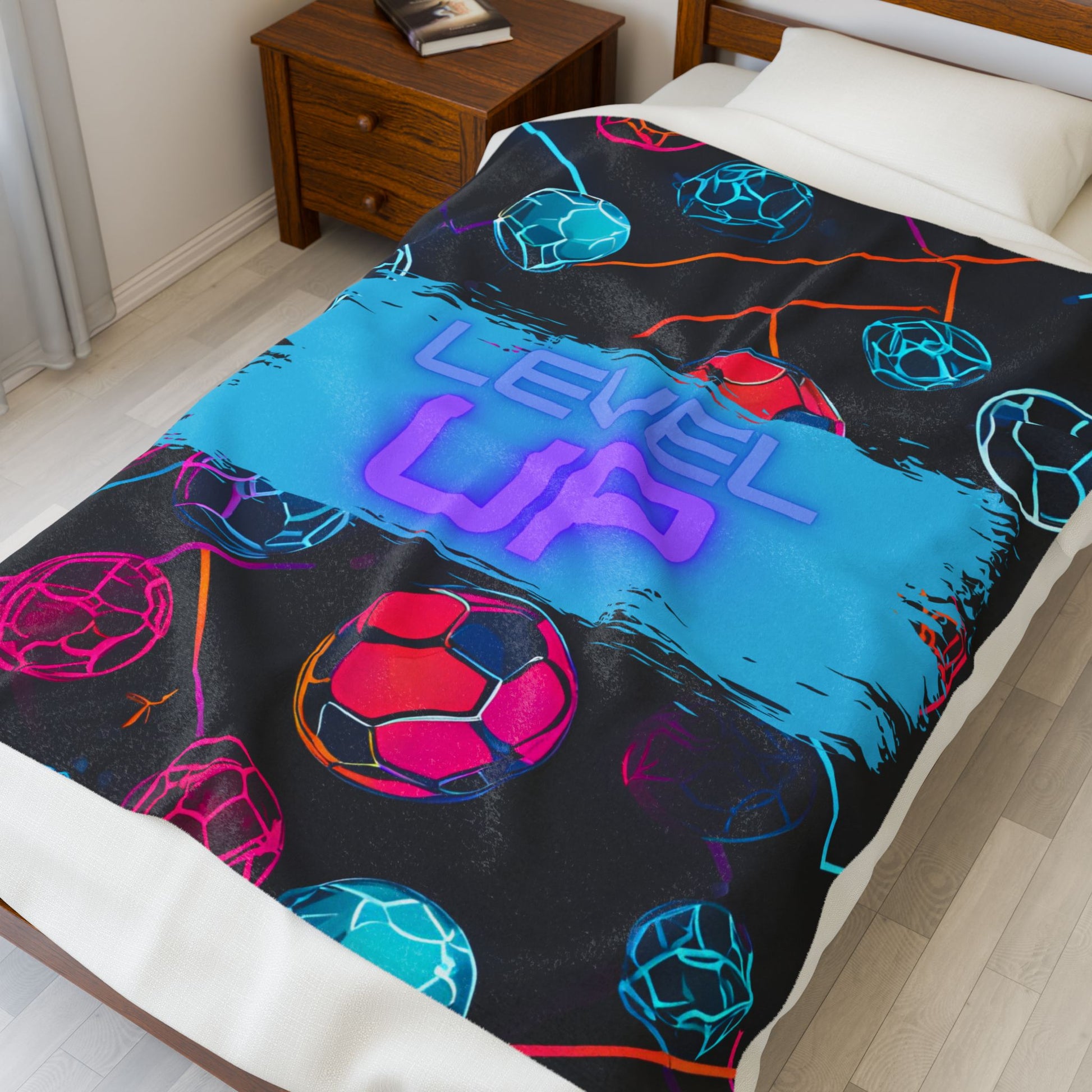 Larger size colorful blanket with 'Level Up' text on a bed in a bedroom setting
